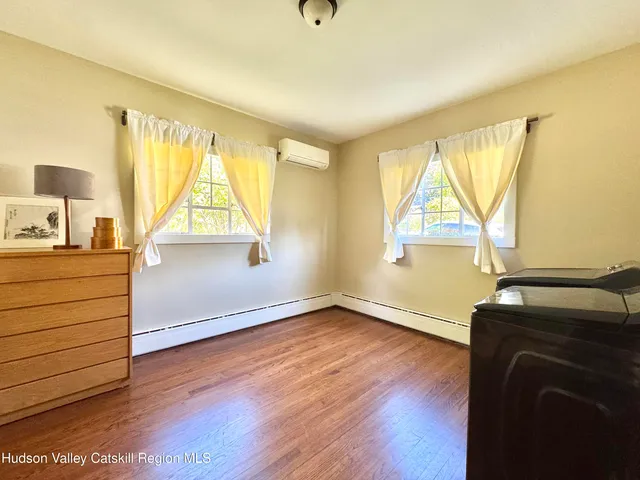 a view of room with wooden floor and windows