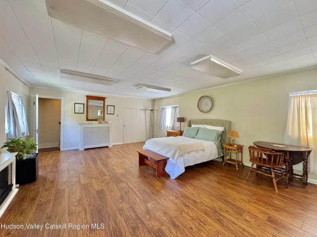 a spacious bedroom with a bed and a table in it