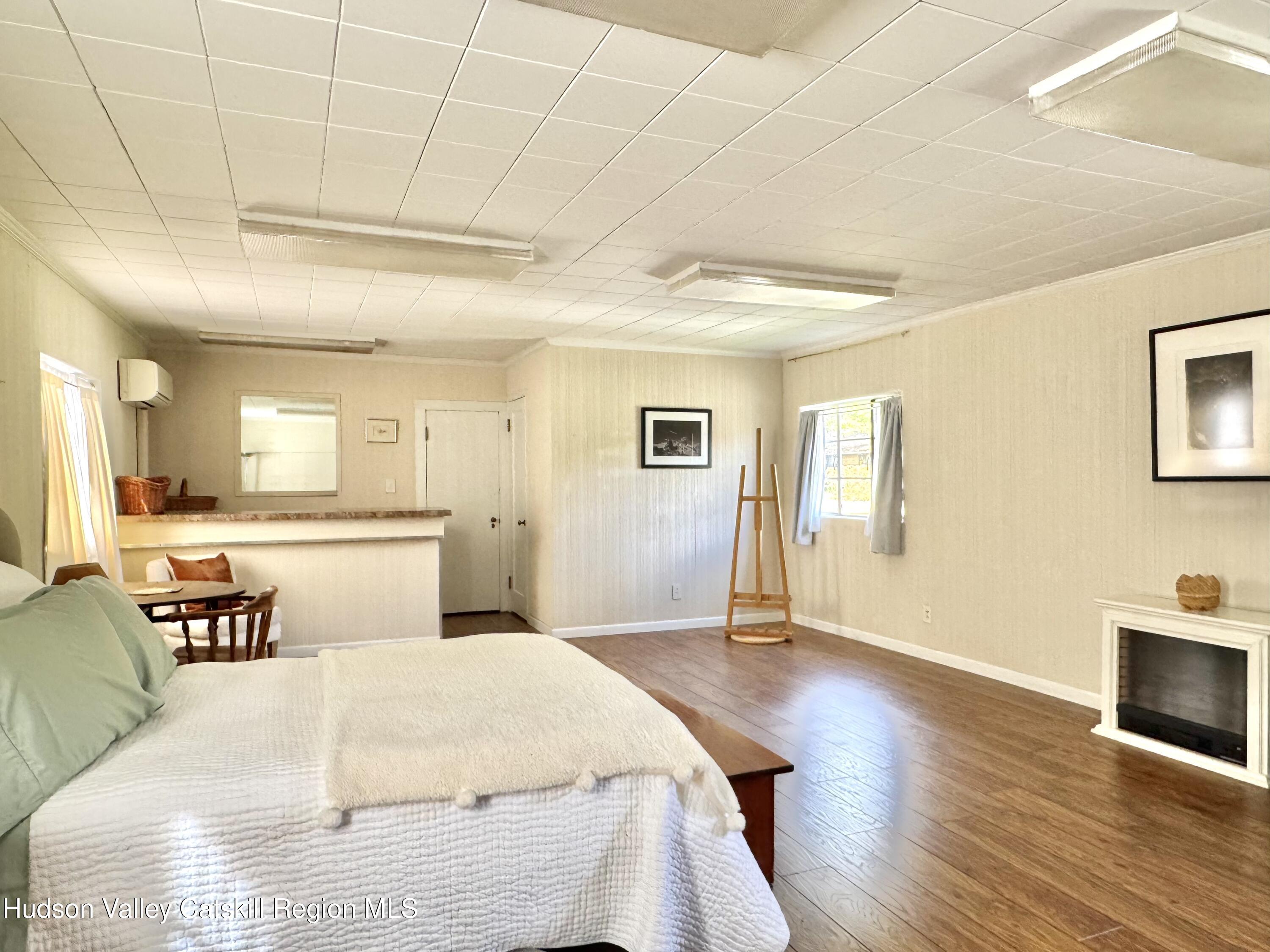 121 High Street Catskill, NY 12414 - Photo 21 of 29 a spacious bedroom with a bed and wooden floor