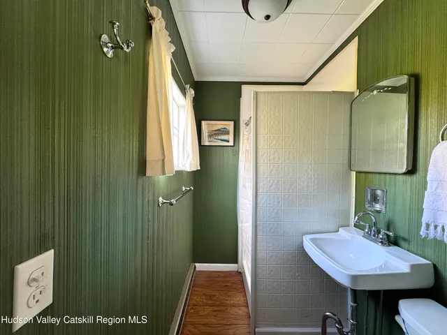 a bathroom with a sink a toilet and mirror