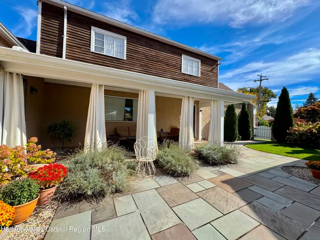 a view of a house with potted plants