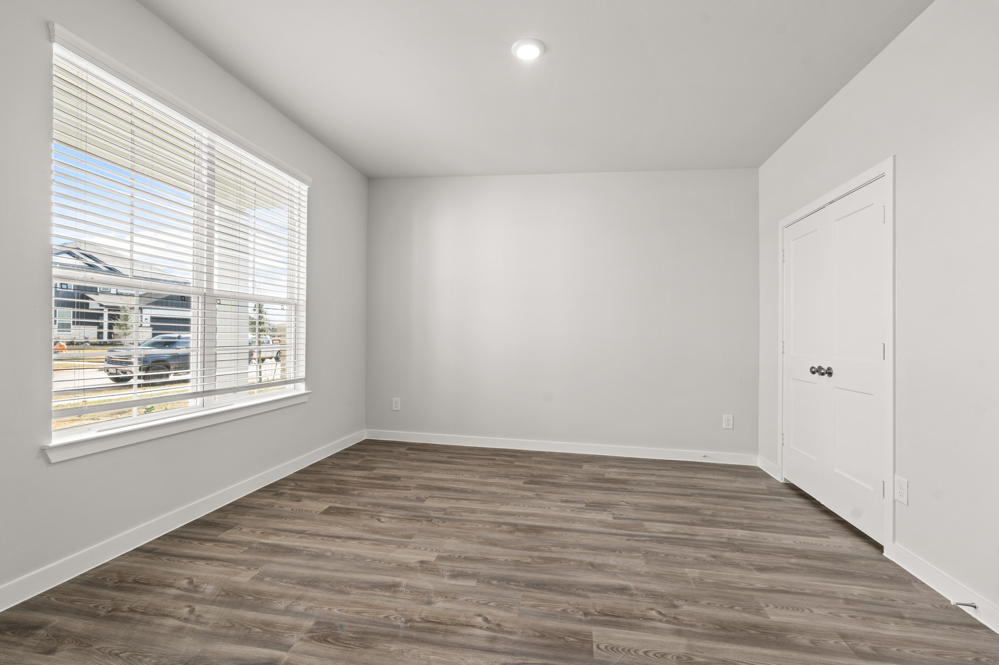 557 Wax Myrtle Way Hockley, TX 77447 - Photo 3 of 25 a view of an empty room with wooden floor and a window