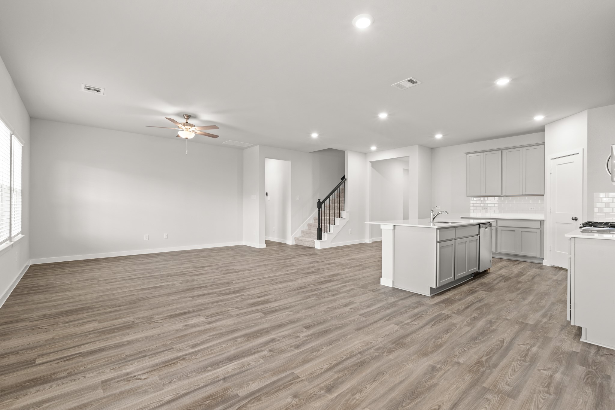 557 Wax Myrtle Way Hockley, TX 77447 - Photo 9 of 25 a view of kitchen with kitchen island microwave and wooden floor