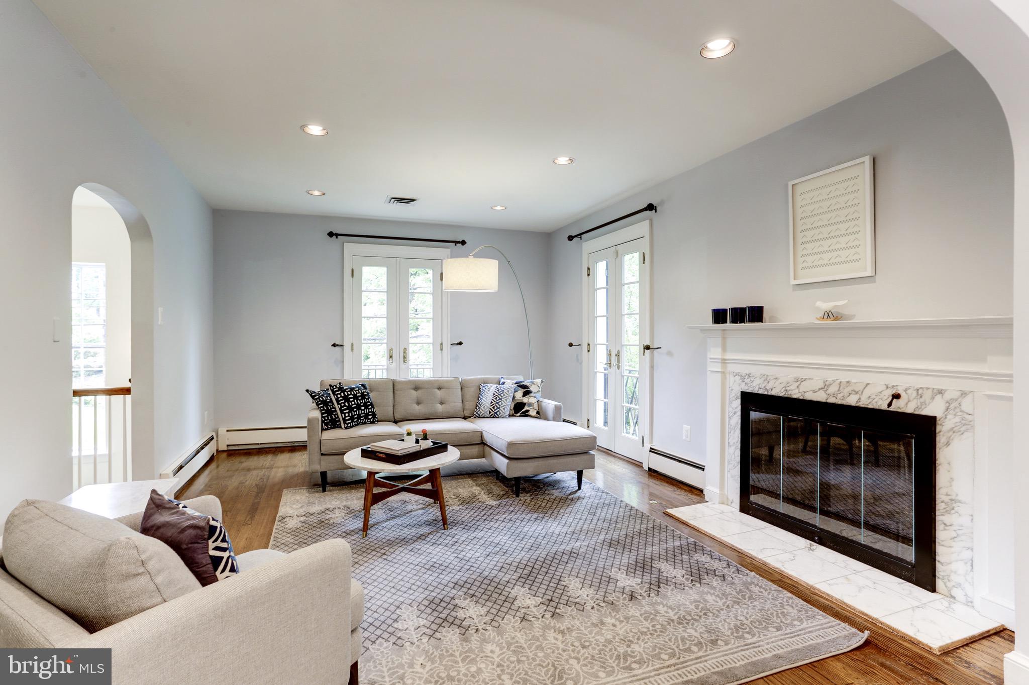 4700 Reservoir Road Northwest Washington, DC 20007 - Photo 11 of 36 a living room with furniture and a fireplace