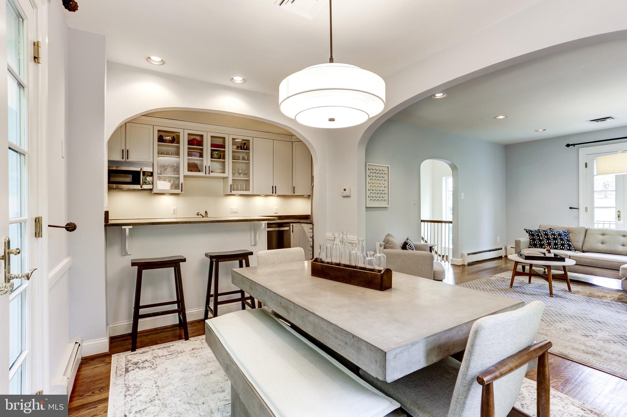 4700 Reservoir Road Northwest Washington, DC 20007 - Photo 15 of 36 a large kitchen with a large counter space a sink appliances and living room view