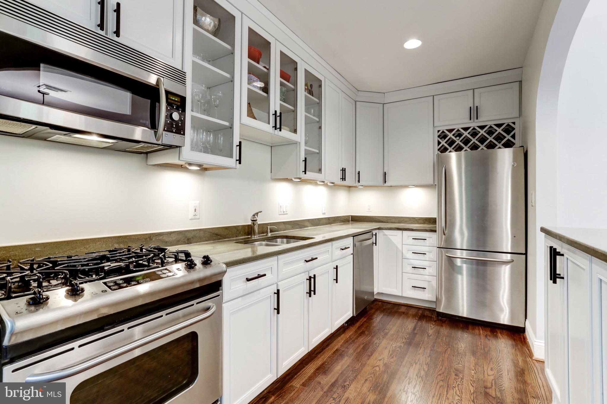 4700 Reservoir Road Northwest Washington, DC 20007 - Photo 17 of 36 a kitchen with stainless steel appliances granite countertop a stove and a refrigerator