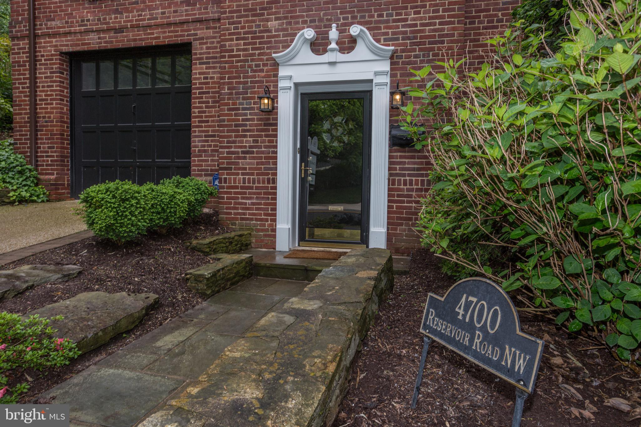 4700 Reservoir Road Northwest Washington, DC 20007 - Photo 2 of 36 a front view of a house with garden