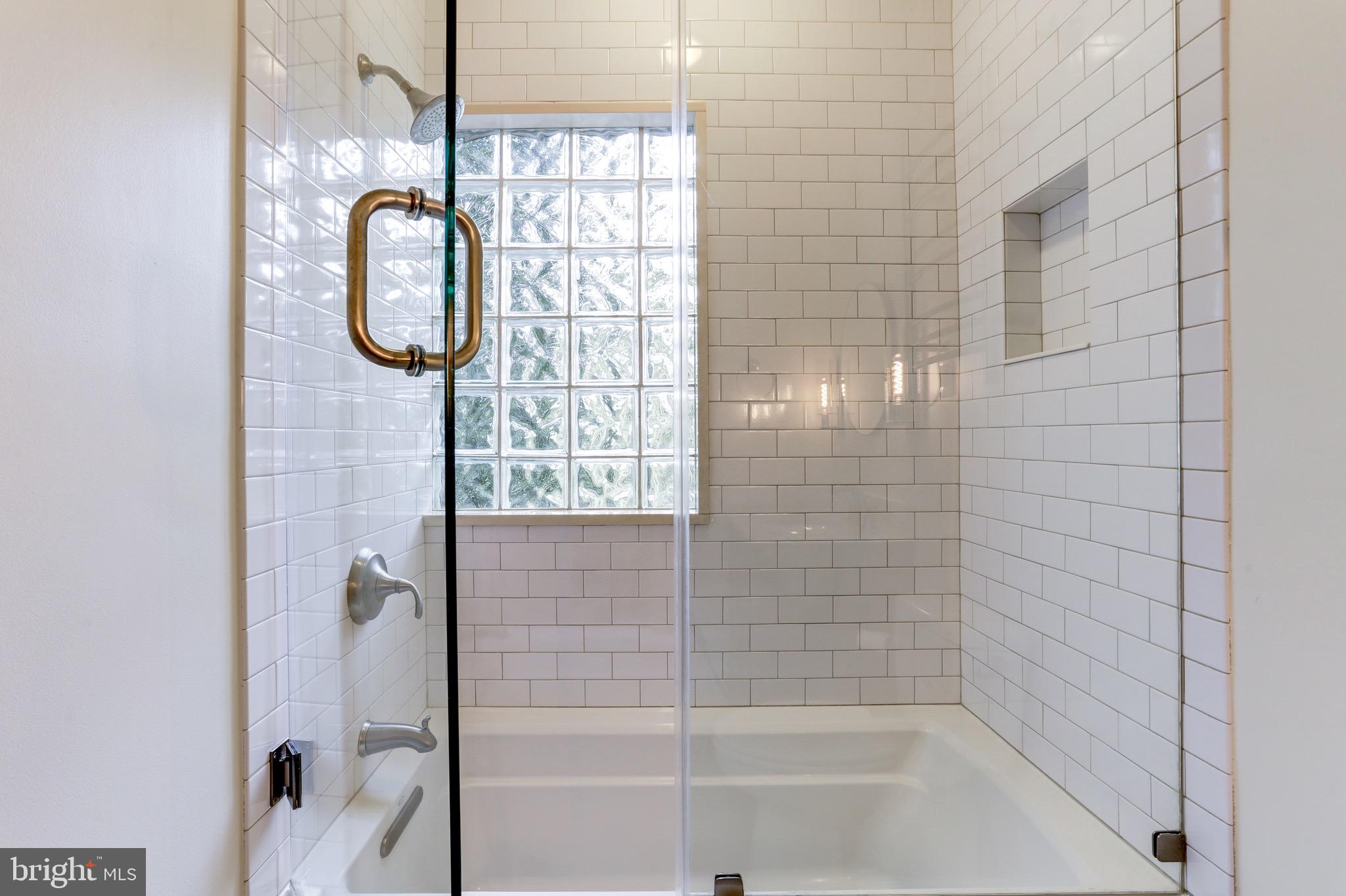 4700 Reservoir Road Northwest Washington, DC 20007 - Photo 26 of 36 a bathroom with a shower a bath tub and shower