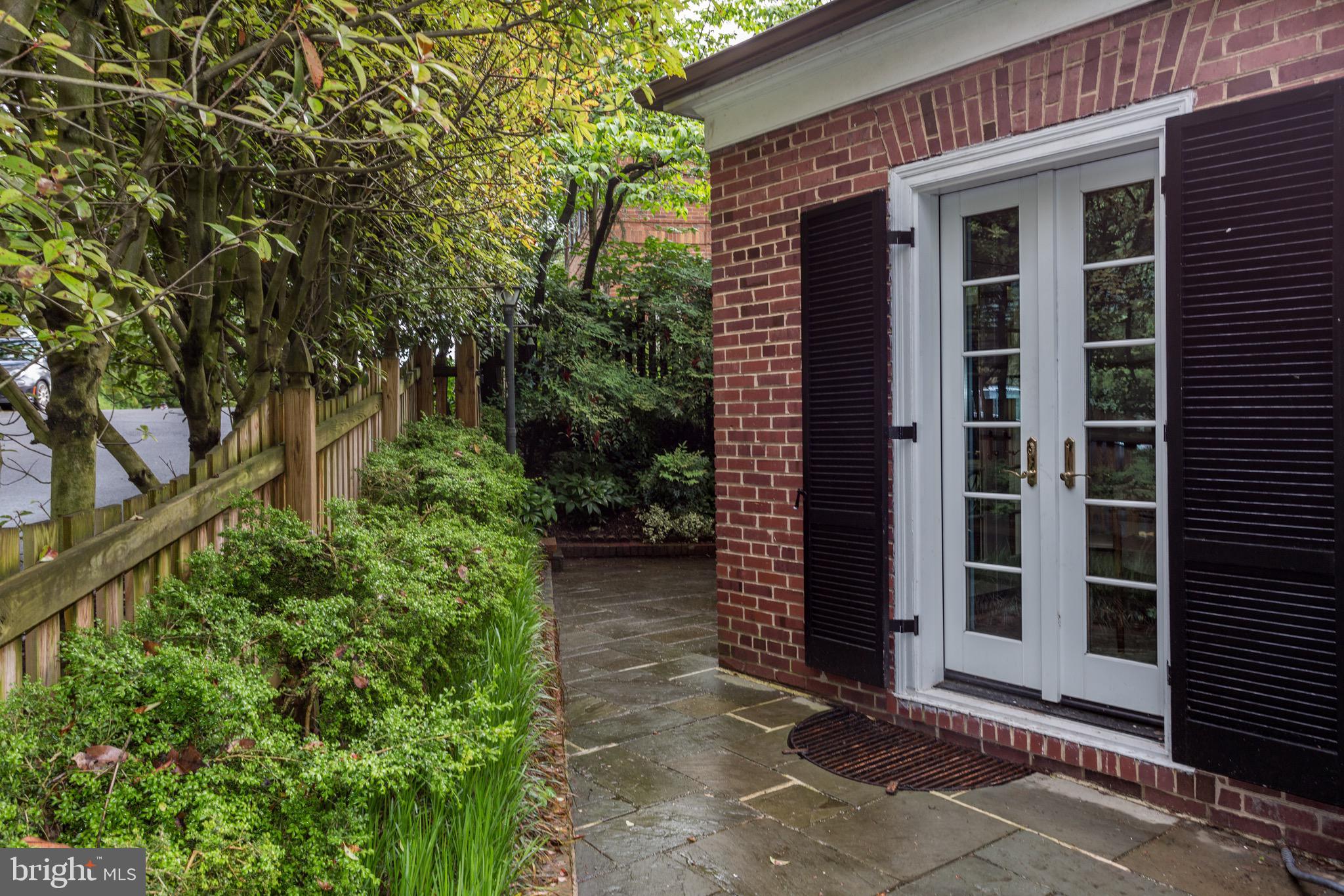 4700 Reservoir Road Northwest Washington, DC 20007 - Photo 30 of 36 a front view of a house with a yard