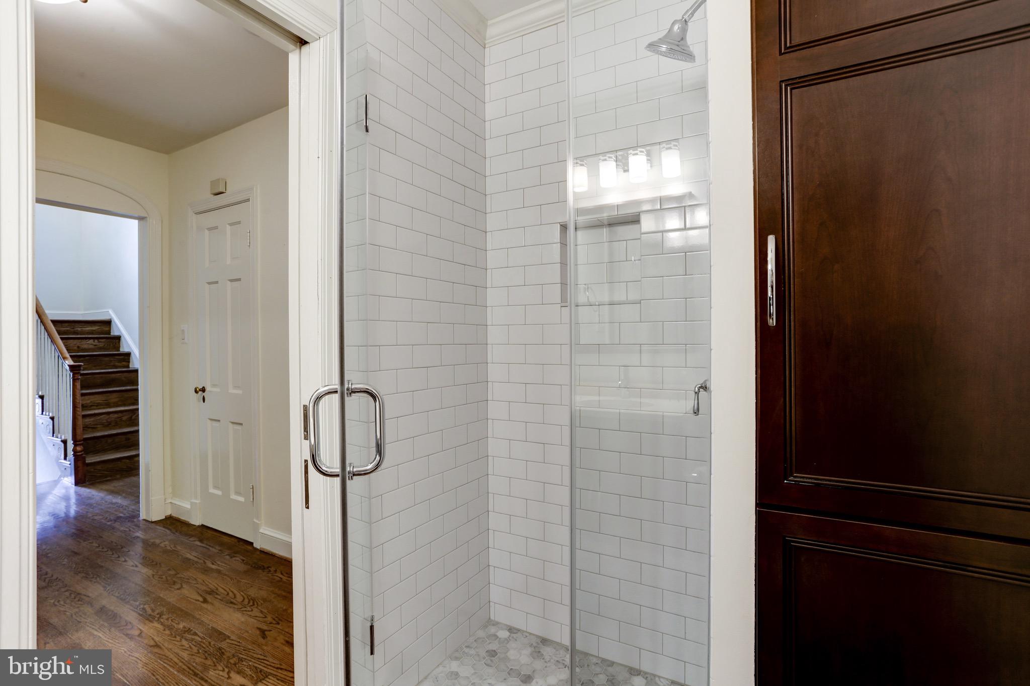 4700 Reservoir Road Northwest Washington, DC 20007 - Photo 9 of 36 a bathroom with a glass shower door
