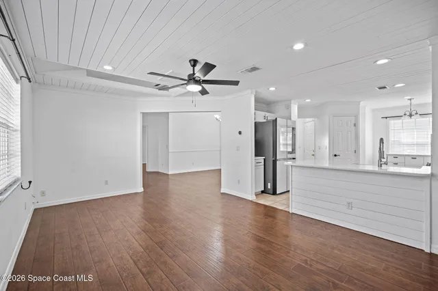 a view of a kitchen with a dishwasher and wooden floor