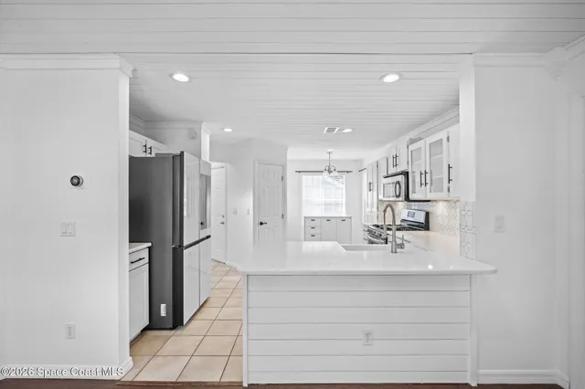 a bathroom with a sink shower and a mirror