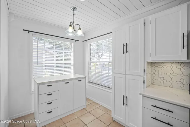 a bathroom with a window sink and cabinets