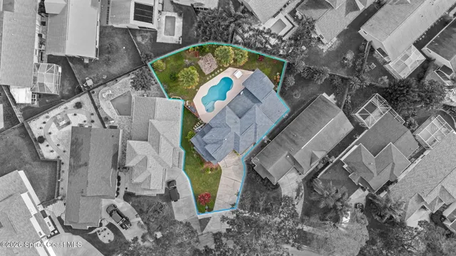 an aerial view of a house with a yard and hanging chair