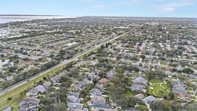 an aerial view of a house with a yard and outdoor seating