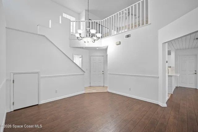 a view of entryway and hall with a chandelier