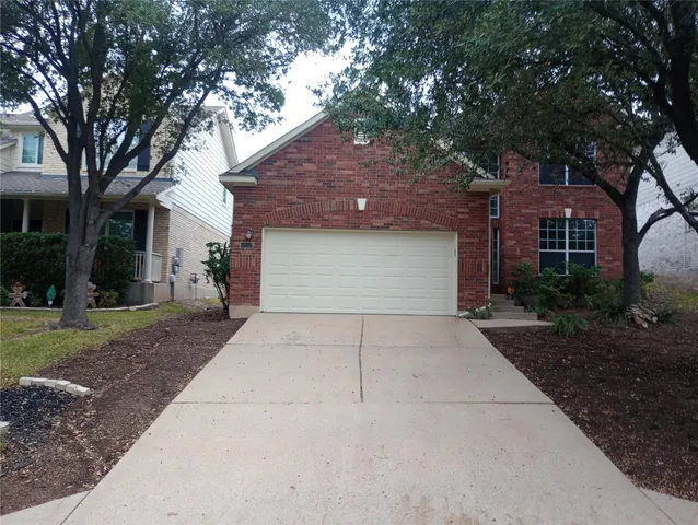 a front view of a house with a yard and a garage