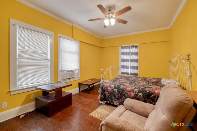 a bedroom with a bed couch and window
