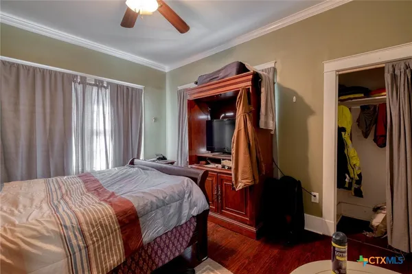 a bedroom with bed and a chandelier