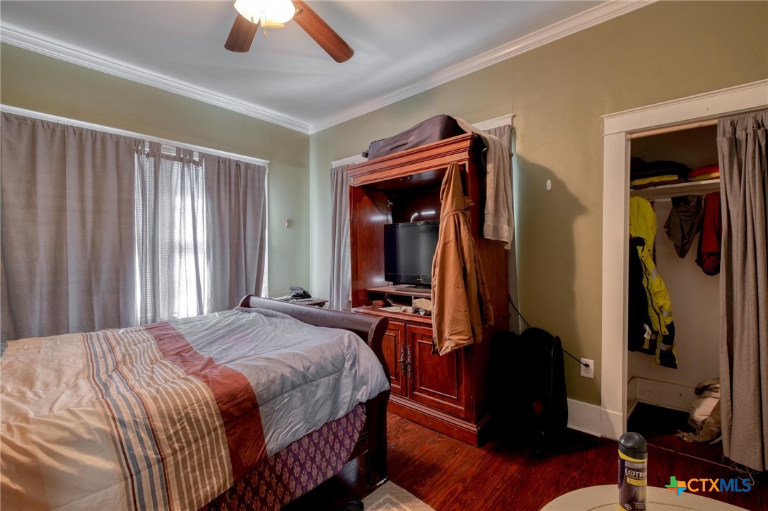 809 South Pecan Avenue Luling, TX 78648 - Photo 13 of 26 a bedroom with bed and a chandelier