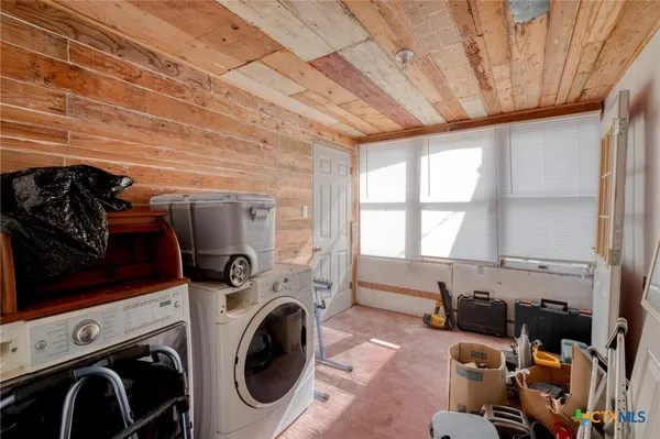 a view of a storage and utility room with washer and dryer