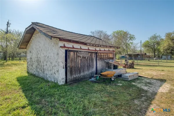 a backyard of a house with table and chairs