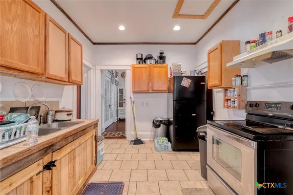 a kitchen with stainless steel appliances a refrigerator sink and stove