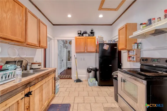 a kitchen with stainless steel appliances a refrigerator sink and stove