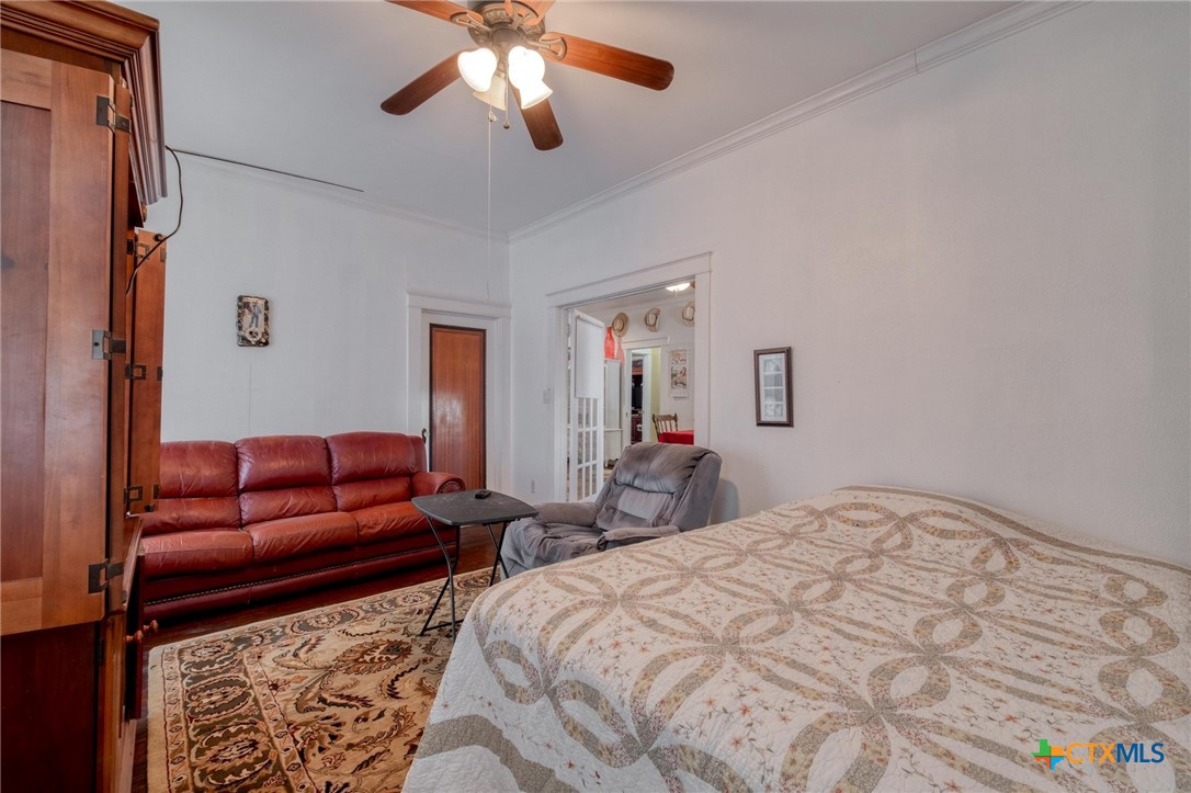 809 South Pecan Avenue Luling, TX 78648 - Photo 10 of 26 a bed room with a bed and a couch