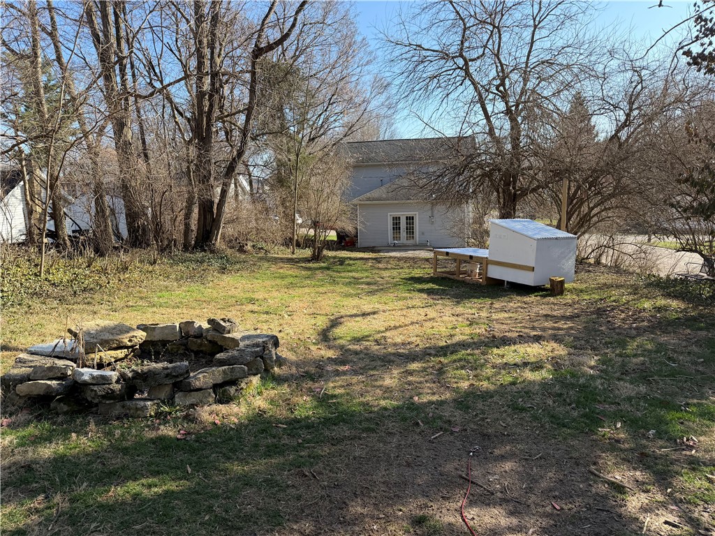 230 West Decatur Street Eaton, OH 45320 - Photo 22 of 22 This spacious yard offers ample outdoor living potential, complete with a cozy stone fire pit.