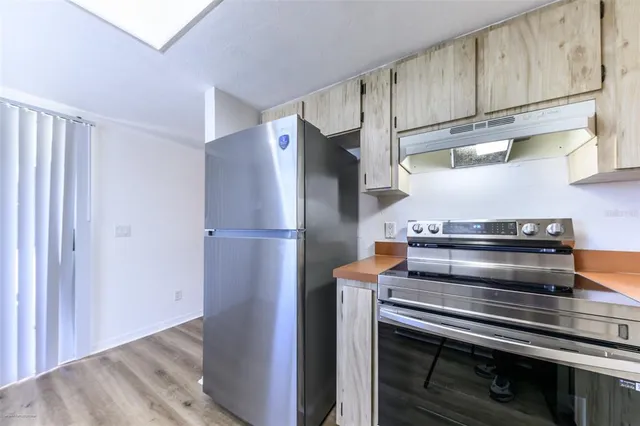 a kitchen with appliances and cabinets