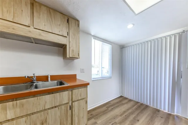 a kitchen with a sink and cabinets