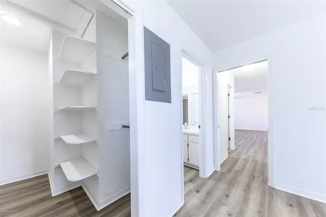 a view of a bathroom from a hallway with wooden floor