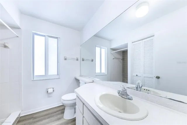a bathroom with a toilet sink and mirror