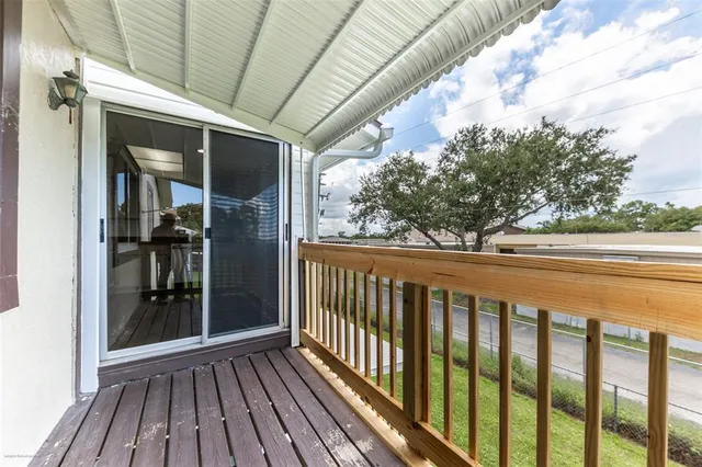 a view of balcony with wooden floor
