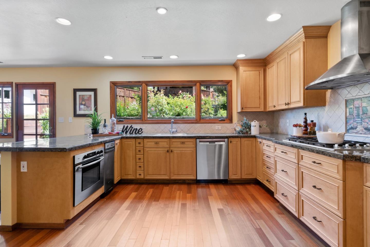 380 Sims Road Santa Cruz, CA 95060 - Photo 13 of 72 a kitchen with stainless steel appliances kitchen island granite countertop a stove a sink and a microwave