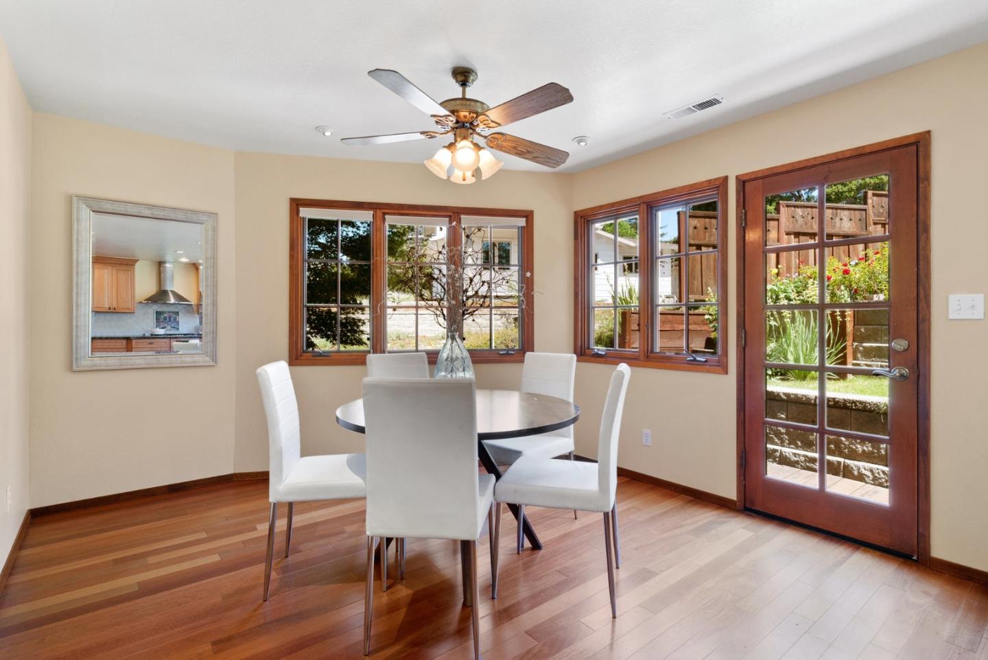 380 Sims Road Santa Cruz, CA 95060 - Photo 19 of 72 a dining room with wooden floor a chandelier a glass table and chairs