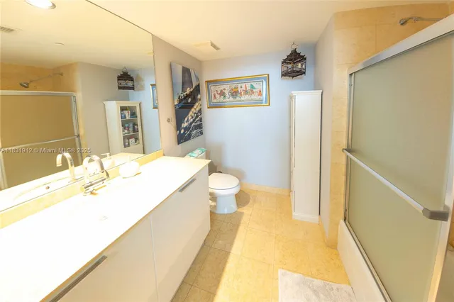 a spacious bathroom with a sink mirror vanity and toilet