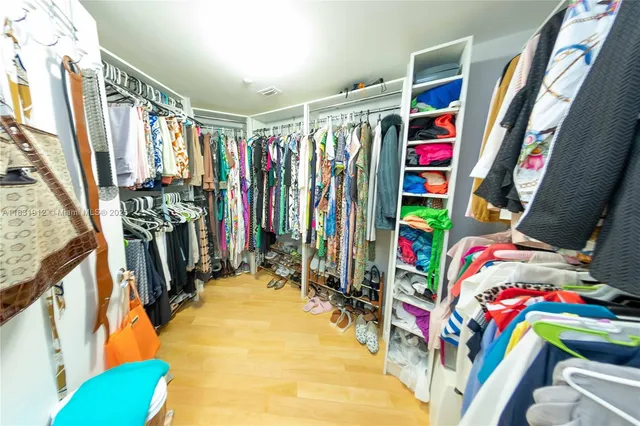 a view of walk in closet with clothes