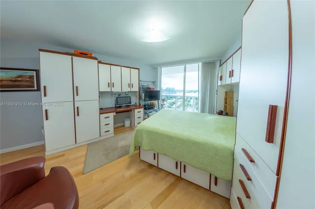 a bed room with a bed and a television