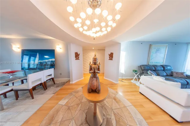 a living room with furniture and a chandelier