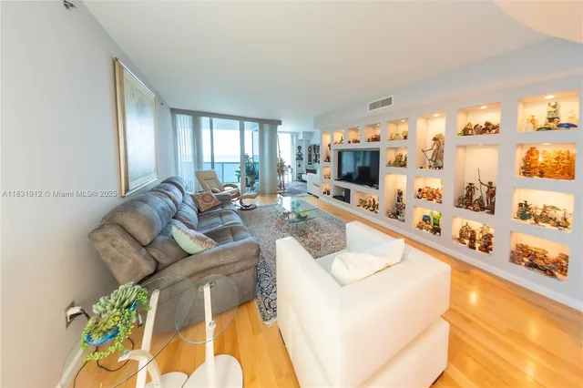 a living room with furniture fireplace and a flat screen tv