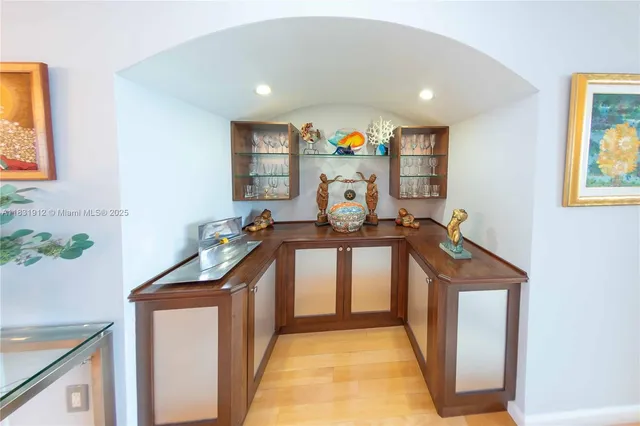 a hallway with a sink and cabinets