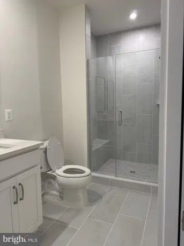 a bathroom with a shower a toilet and a sink
