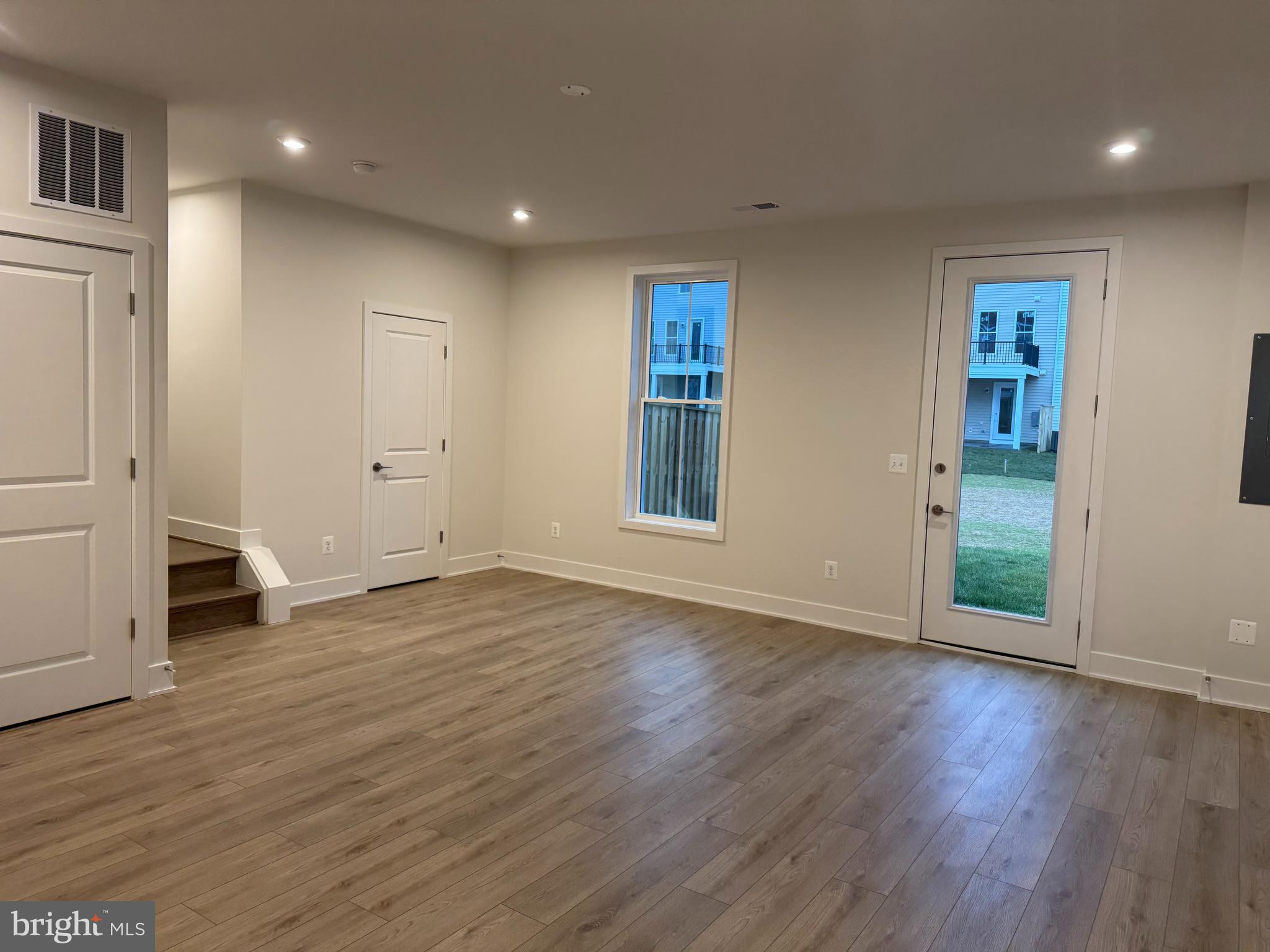 112 Galaxy Place Stephenson, VA 22656 - Photo 24 of 31 an empty room with wooden floor and windows