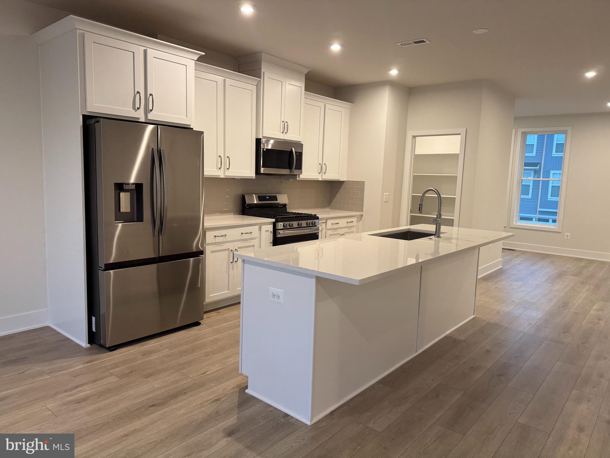 112 Galaxy Place Stephenson, VA 22656 - Photo 4 of 31 a kitchen with stainless steel appliances granite countertop a refrigerator a stove a sink and a microwave