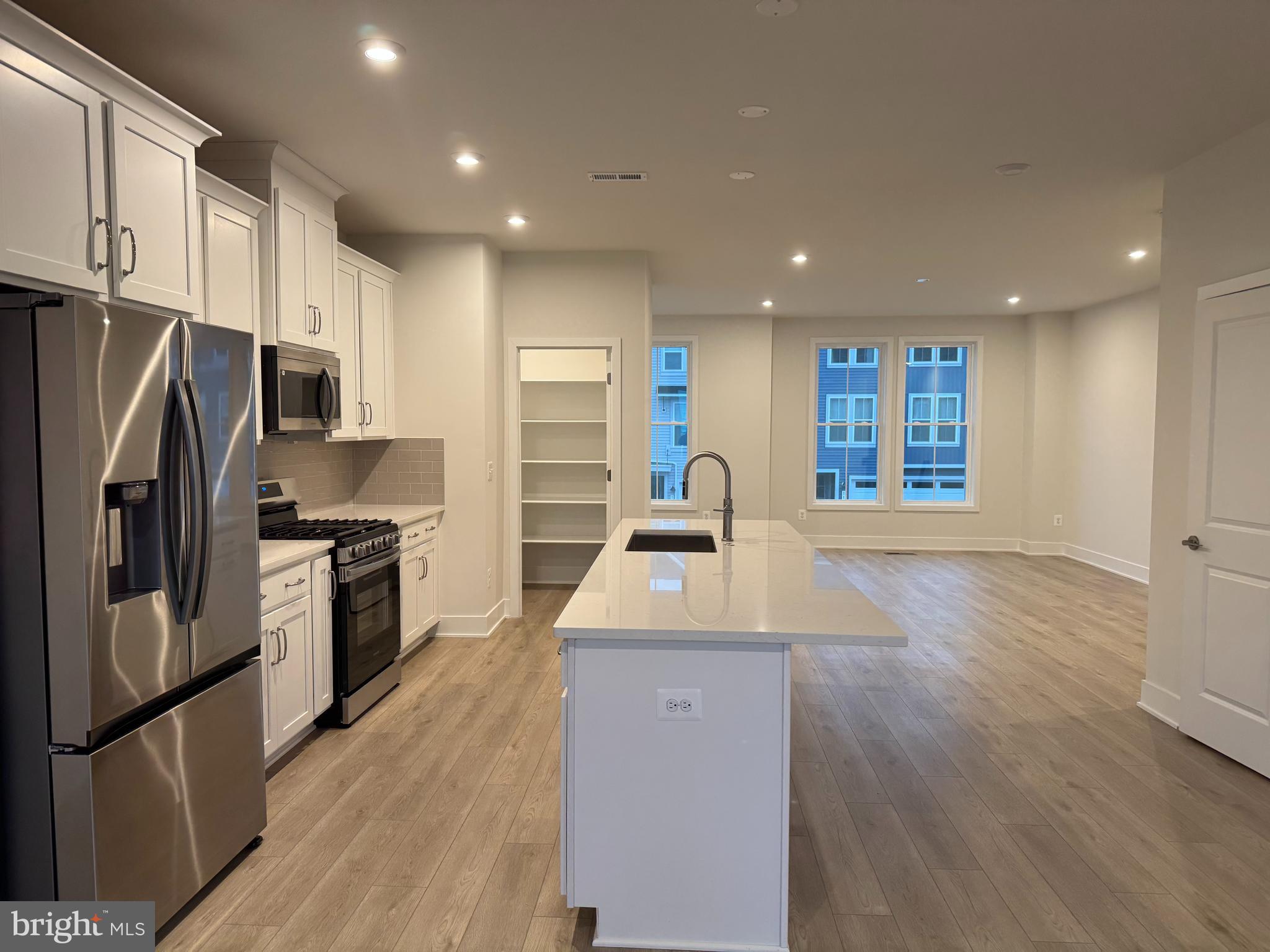 112 Galaxy Place Stephenson, VA 22656 - Photo 6 of 31 a kitchen with stainless steel appliances granite countertop a refrigerator a sink a stove a microwave oven and a refrigerator with wooden floor