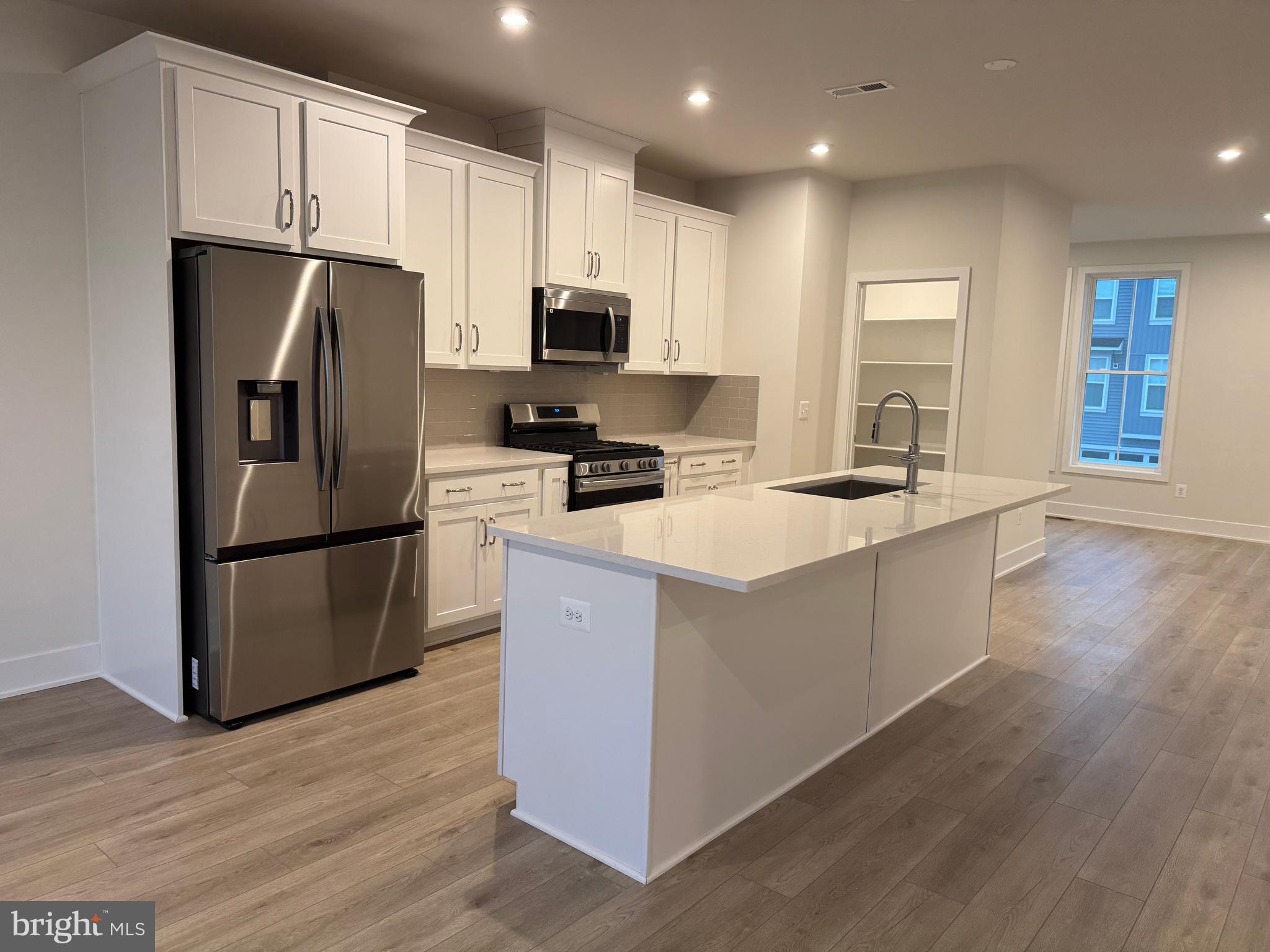 112 Galaxy Place Stephenson, VA 22656 - Photo 7 of 31 a kitchen with stainless steel appliances granite countertop a refrigerator a stove a sink and a microwave