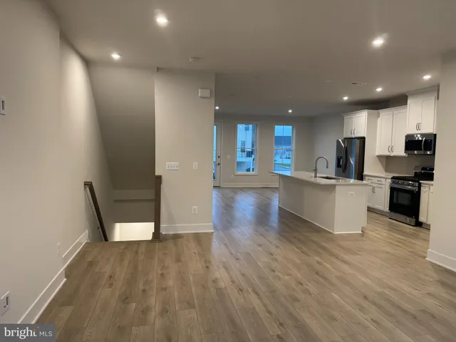 a view of kitchen with cabinets and wooden floor
