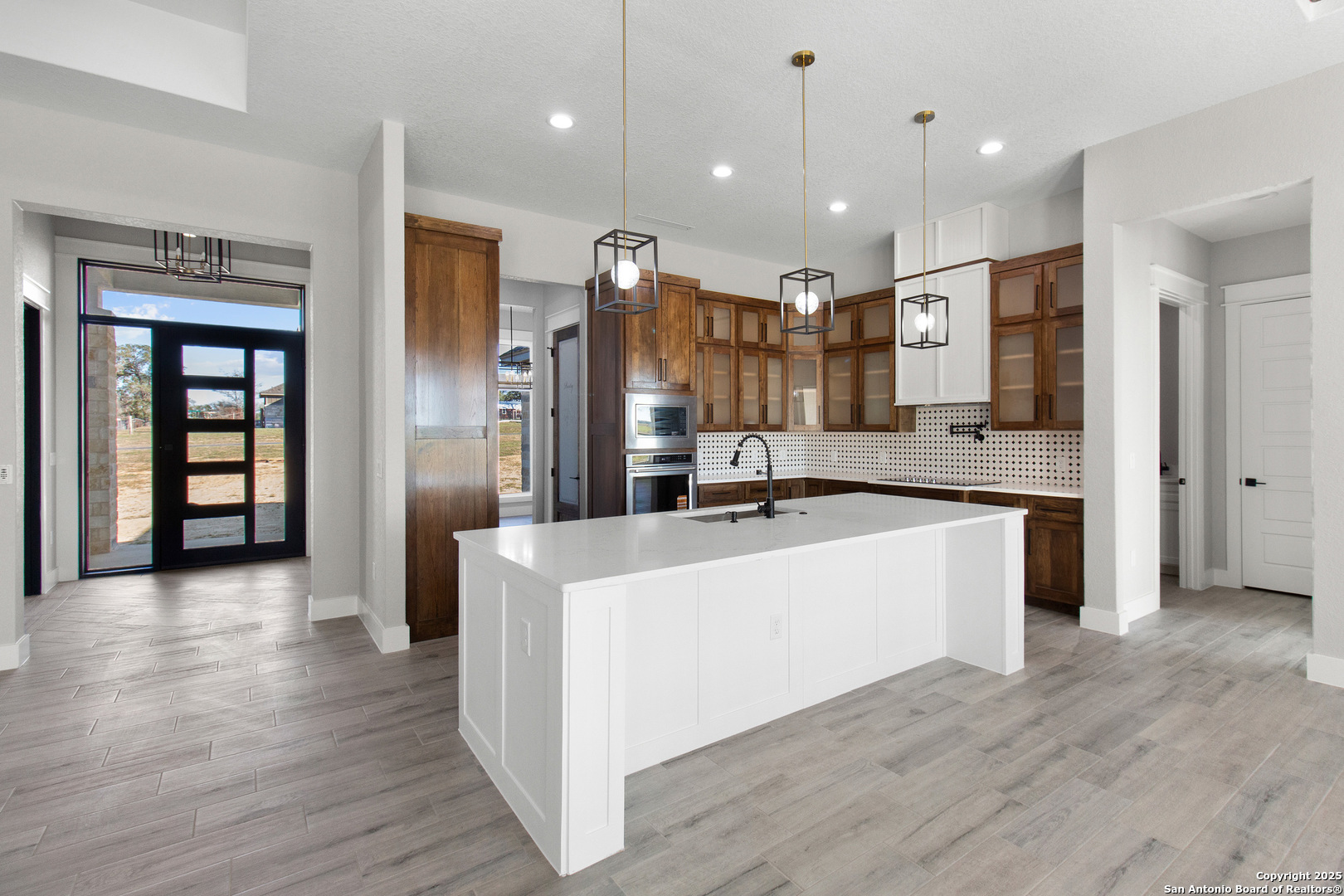 116 Western Way Adkins, TX 78101 - Photo 17 of 50 a large kitchen with stainless steel appliances kitchen island a large counter top and a wooden floors